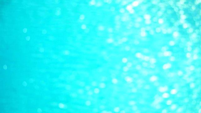 blur little pure clear blue color of water in pool surface with light reflections sunlight