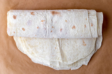 Thin pita bread on baking paper. Armenian pita bread close-up.