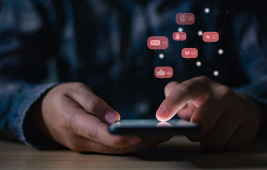 Low key man hand using phone or mobile or smartphone,,Social media and business concept