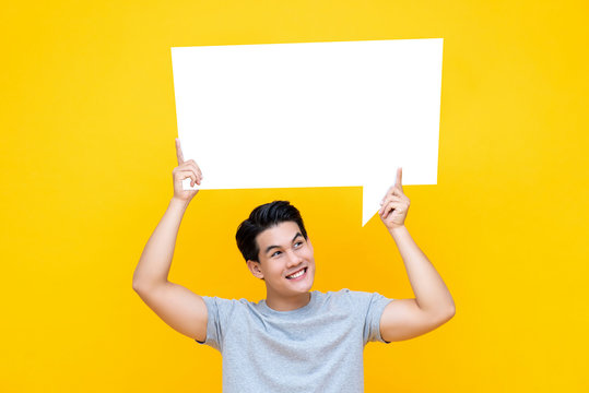 Happy Smiling Young Handsome Asian Man Holding Speech Bubble