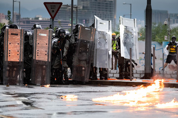 Hong Kong police after a protestor throws a molotov cocktail at them