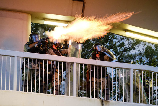 Hong Kong Policeman firing teargas at protestors
