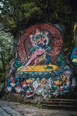 Tibetan murals in the stone wall carvings of Dongga Temple, Hailuogou, Sichuan, China, Thangka, rock carving