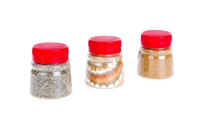 Jars with ground dried spices, herb. Photo