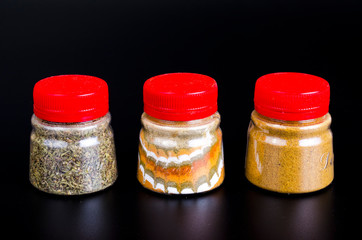 Jars with ground dried spices, herb. Photo