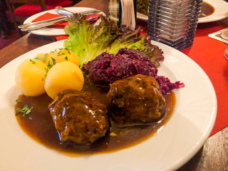 Tasty stewed meat, red cabbage and potato dumplings