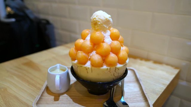 bingsoo cantaloupe on wooden table ,Korean ice dessert
