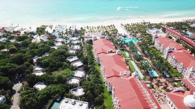 Top view of beautiful beach. Aerial drone shot of turquoise sea water at the beach. Luxury tropical resort with white sand. Aerial view