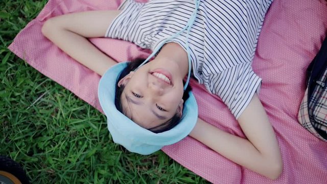 Beautiful Asian Teenager Girl Lying on the Meadow and Dreaming. Enjoy Nature, Close up Slow Motion