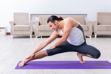 Young man training and exercising at home