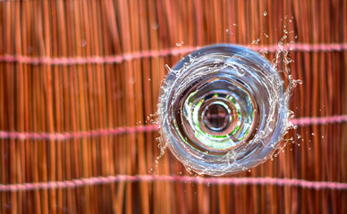 A top view of a glass of water and splashes