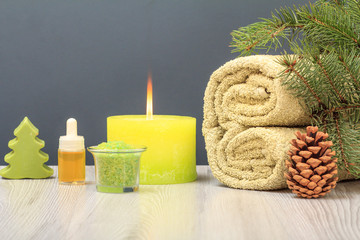 Obraz na płótnie Canvas Spa composition with towel, aromatic oil, soap, sea salt and candle