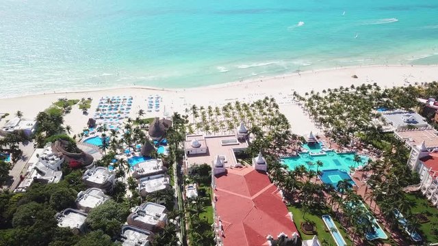 Top view of beautiful beach. Aerial drone shot of turquoise sea water at the beach. Luxury tropical resort with white sand. Aerial view