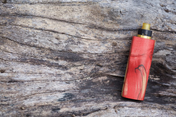 high end red natural stabilized wood regulated box mods with rebuildable dripping atomizer on...