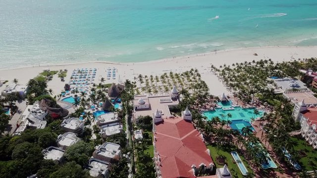 Top view of beautiful beach. Aerial drone shot of turquoise sea water at the beach. Luxury tropical resort with white sand. Aerial view