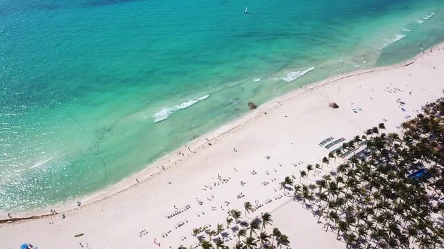 Top view of beautiful beach. Aerial drone shot of turquoise sea water at the beach. Luxury tropical resort with white sand. Aerial view