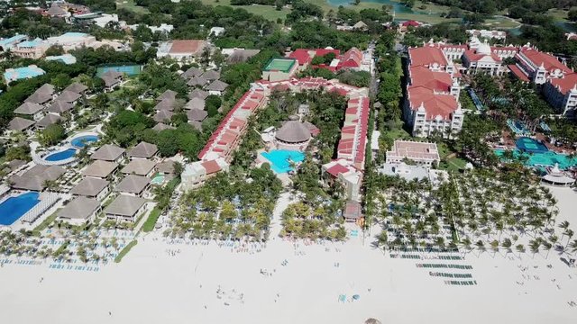 Top view of beautiful beach. Aerial drone shot of turquoise sea water at the beach. Luxury tropical resort with white sand. Aerial view