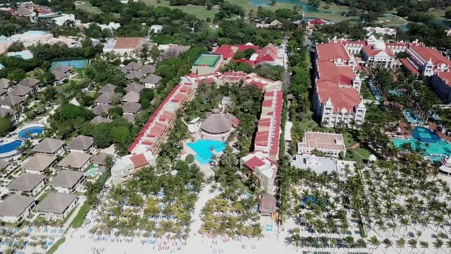 Top view of beautiful beach. Aerial drone shot of turquoise sea water at the beach. Luxury tropical resort with white sand. Aerial view
