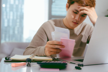 Stressed Asian Business man due to the of amount of work he has to do.