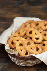 Cookies with sugar in a basket on a wooden table