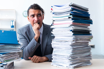 Businessman with heavy paperwork workload