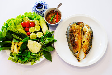 Fried mackerel,vegetable,and sauce on white background