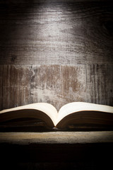 Vintage book on blackboard background