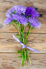 Autumn aster flowers multicolored on wooden background