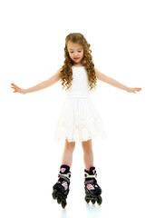 Little girl on roller skates.