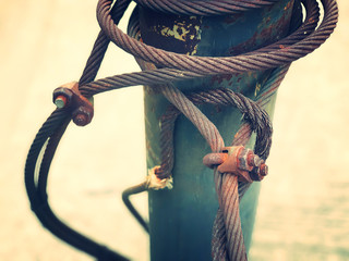 Steel wire rope tighten the steel pole by clamp lock and all are in old and rusted condition