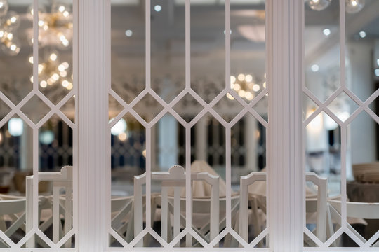 Beautiful large white decorative vintage indoor dining room window with table setting in the background.