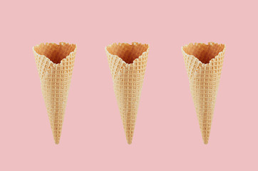 Set of three empty crisp ice cream cones on pink background, mock up for advertising, design, menu, summer food.