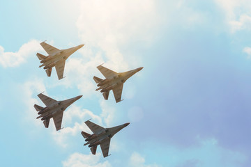Group of four aircraft fighter jet airplane sun glow toned gradient clouds sky. - obrazy, fototapety, plakaty