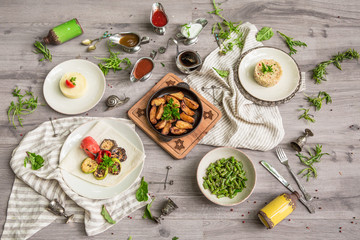 Food Table Celebration Delicious Party Meal Concept. A lot of food on the wooden table: meat, vegetables, desserts, garnishes.  Foodset from Georgian dishes. Caucasian food