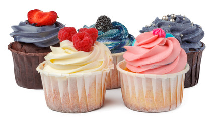 Group of cupcakes with colored topping isolated on white background