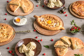 Food Table Celebration Delicious Party Meal Concept. A lot of food on the wooden table: meat, vegetables, desserts, garnishes.  Foodset from Georgian dishes. Caucasian food