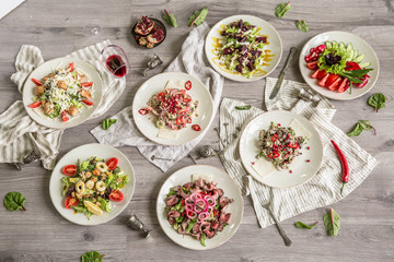 Food Table Celebration Delicious Party Meal Concept. A lot of food on the wooden table: meat, vegetables, desserts, garnishes.  Foodset from Georgian dishes. Caucasian food