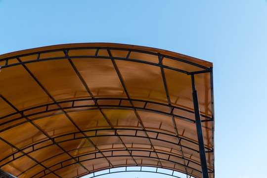 plastic carport. brown transparent roof made of polycarbonate with metal  structures Stock Photo | Adobe Stock