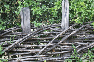 wicker crooked rural fence, country fence in mountains