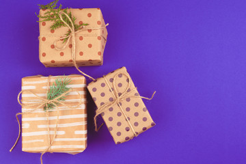 Gift box on purple background top view
