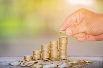 Man's hand put money coins to stack of coins ,Money, Financial, Business Growth concept,