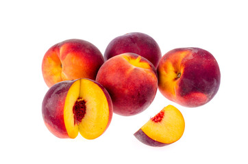 Several ripe sweet peaches isolated on white background.