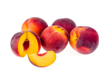 Several ripe sweet peaches isolated on white background.