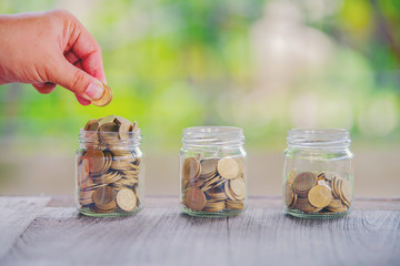 Hold put on the stack coin with growing in the public park, Savings money for buy house and loan to business investment for real estate concept.