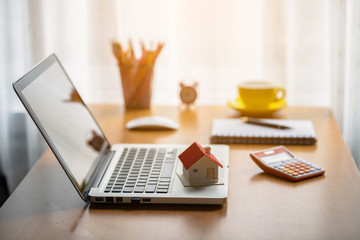 Holding house representing home ownership and the Real Estate business