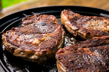 Grilled beef steak on the grill, close-up.