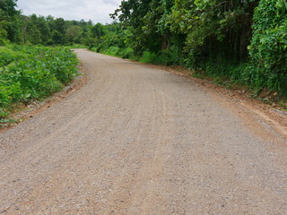 A dirt mixed with small granite road commonly seen in a rural area in the North of Thailand
