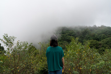 young cute Japanese Asian hipster girl travelling at beautiful sky  mountains scenery park hiking garden views at Kanchanaburi Thailand guiding  idea for female backpacker woman women backpacking