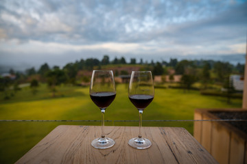 happy hipster lover couple guiding resting relaxing drinking wine together  at beautiful blue sky mountains hills green forest scenery garden park  grass field outdoors views Kanchanaburi, Thailand.