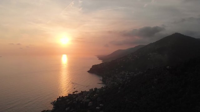 In Portofino, the drone flies at golden hour and slowly lowers showing off the mountains and the Mediterranean Sea.
